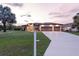 Charming single-story home with manicured lawn, a two-car garage, and inviting entrance, perfect for families at 1275 Blue Lake Cir, Punta Gorda, FL 33983