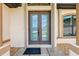 Elegant double glass front door with sidelights and decorative stone accents at 1275 Blue Lake Cir, Punta Gorda, FL 33983