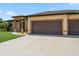 Spacious three-car garage with a concrete driveway and well-maintained lawn at 1275 Blue Lake Cir, Punta Gorda, FL 33983