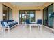 A covered outdoor patio with tile flooring, comfortable seating, and sliding glass doors at 1275 Blue Lake Cir, Punta Gorda, FL 33983