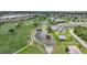A condo building in a golf community with a pool and pond at 1375 Saxony Cir # 124, Punta Gorda, FL 33983