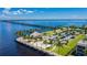 Aerial view of waterway, a bridge, a beach with palms, parking spaces, a park and green landscaping at 1375 Saxony Cir # 124, Punta Gorda, FL 33983