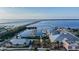 Aerial view of a marina, pier, and bridge in the distance at 1375 Saxony Cir # 124, Punta Gorda, FL 33983