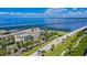 An aerial view of a road with palm trees, apartments, a bridge and a waterway on a clear day at 1375 Saxony Cir # 124, Punta Gorda, FL 33983
