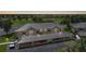 Exterior aerial view of condos featuring covered parking, lush landscaping, and a golf course backdrop at 1375 Saxony Cir # 124, Punta Gorda, FL 33983