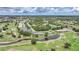 An aerial view of a golf community with a pond and neighborhood at 1375 Saxony Cir # 124, Punta Gorda, FL 33983