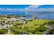 Picturesque aerial view of marina with a green park, waterway, bridge and buildings with palms at 1375 Saxony Cir # 124, Punta Gorda, FL 33983