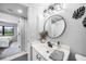 Bright bathroom with a sleek vanity and mirror, complemented by a view into the adjacent bedroom at 1375 Saxony Cir # 124, Punta Gorda, FL 33983