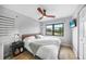 Bright bedroom features a ceiling fan and a window with a pleasant outdoor view at 1375 Saxony Cir # 124, Punta Gorda, FL 33983