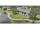 A condo building on the water with a grassy area at 1375 Saxony Cir # 124, Punta Gorda, FL 33983