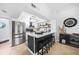 Modern kitchen featuring stainless steel appliances, a stylish island with seating, and an eye-catching light fixture at 1375 Saxony Cir # 124, Punta Gorda, FL 33983