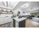 Bright open-concept kitchen flowing into a living area, featuring modern white cabinets and stylish decor at 1375 Saxony Cir # 124, Punta Gorda, FL 33983