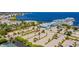 Aerial view of boat parking, a blue building, palm trees, parking lots and a waterfront view at 1375 Saxony Cir # 124, Punta Gorda, FL 33983