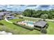 Aerial view of the pool area with seating and lush greenery in a well-maintained community at 1375 Saxony Cir # 124, Punta Gorda, FL 33983