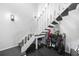 Bright staircase with contemporary design, featuring black treads and white railings, near golf equipment storage at 1375 Saxony Cir # 124, Punta Gorda, FL 33983