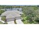 Aerial view of a home featuring a beautiful tile roof, three-car garage, and mature landscaping at 14311 Reserve Ct, Port Charlotte, FL 33953