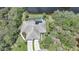 An aerial view of a home with a screened-in pool and a three-car garage at 14311 Reserve Ct, Port Charlotte, FL 33953