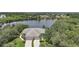 Aerial view of home, showcasing its proximity to a scenic lake and lush landscaping at 14311 Reserve Ct, Port Charlotte, FL 33953