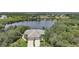 Aerial view of a home featuring a tile roof, three-car garage, mature trees and landscaping at 14311 Reserve Ct, Port Charlotte, FL 33953