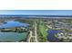 Stunning aerial view of a golf course community with homes, lakes and lush greenery at 14311 Reserve Ct, Port Charlotte, FL 33953