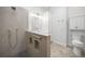 Contemporary bathroom showcasing a walk-in shower, tiled floors, and a built-in linen cabinet at 14311 Reserve Ct, Port Charlotte, FL 33953