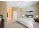 A bright bedroom featuring neutral colors, carpet, and an ensuite bathroom at 14311 Reserve Ct, Port Charlotte, FL 33953