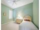 Cozy bedroom with light green walls, a ceiling fan, and a twin bed at 14311 Reserve Ct, Port Charlotte, FL 33953