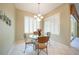 Cozy dining area with a glass-top table, chandelier, and views of the garden at 14311 Reserve Ct, Port Charlotte, FL 33953