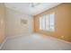 Bright bedroom with neutral carpet, white ceiling fan, and a large window at 14311 Reserve Ct, Port Charlotte, FL 33953