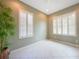 Bright, neutral-toned room with tile floors, plantation shutters, and ample space at 14311 Reserve Ct, Port Charlotte, FL 33953