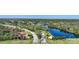 Wide shot of the entrance to a neighborhood with dual signs and lush greenery at 14311 Reserve Ct, Port Charlotte, FL 33953