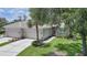 Charming single-story home with a three-car garage, a well-manicured lawn, and lush tropical landscaping at 14311 Reserve Ct, Port Charlotte, FL 33953