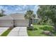 Charming home featuring a well-manicured lawn and a three car garage at 14311 Reserve Ct, Port Charlotte, FL 33953