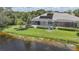 Exterior view of a home with a screened-in pool area and a lake view at 14311 Reserve Ct, Port Charlotte, FL 33953