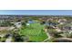 Picturesque golf course with neatly striped fairways, a reflective pond, and surrounding residential homes at 14311 Reserve Ct, Port Charlotte, FL 33953