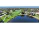 Scenic golf course with lush green fairways, a tranquil pond, and mature trees enhancing the landscape at 14311 Reserve Ct, Port Charlotte, FL 33953