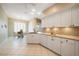 Bright kitchen with stainless steel appliances, white cabinetry, and an adjacent dining area at 14311 Reserve Ct, Port Charlotte, FL 33953
