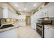 Well-equipped kitchen featuring white cabinets, granite countertops, and stainless steel appliances at 14311 Reserve Ct, Port Charlotte, FL 33953