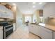 Bright kitchen featuring white cabinetry, granite countertops, and an adjacent breakfast nook at 14311 Reserve Ct, Port Charlotte, FL 33953