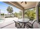 Inviting screened lanai with a dining table and views of the lake and pool at 14311 Reserve Ct, Port Charlotte, FL 33953