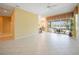 Open-concept living area with neutral walls and tile floors that flow seamlessly to the outdoors at 14311 Reserve Ct, Port Charlotte, FL 33953
