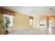 Open living room featuring large windows, plantation shutters, and tile flooring at 14311 Reserve Ct, Port Charlotte, FL 33953