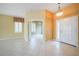Inviting living room with tile flooring and large windows, leading to other rooms at 14311 Reserve Ct, Port Charlotte, FL 33953