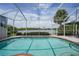Sparkling pool offers a tranquil view of the lake surrounded by lush landscaping and clear blue skies at 14311 Reserve Ct, Port Charlotte, FL 33953