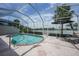 Enclosed pool area features a relaxing patio with a beautiful lake view at 14311 Reserve Ct, Port Charlotte, FL 33953