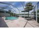Enclosed pool area features a relaxing patio with a beautiful lake view at 14311 Reserve Ct, Port Charlotte, FL 33953