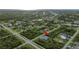 Aerial view showcasing the home's location in a residential area, near canals and green spaces at 14520 Edna Cir, Port Charlotte, FL 33981