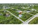 Aerial shot capturing the home's location within a lush residential area with neighboring houses and foliage at 14520 Edna Cir, Port Charlotte, FL 33981