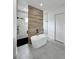 Modern bathroom featuring a soaking tub and glass-enclosed shower with marble and wood-style tile accents at 14520 Edna Cir, Port Charlotte, FL 33981