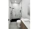 A stylish bathroom with a glass-enclosed shower with marbled walls and black shower hardware at 14520 Edna Cir, Port Charlotte, FL 33981